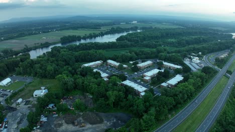 highway along side of connecticut river bend next to apartment townhomes and gravel pit