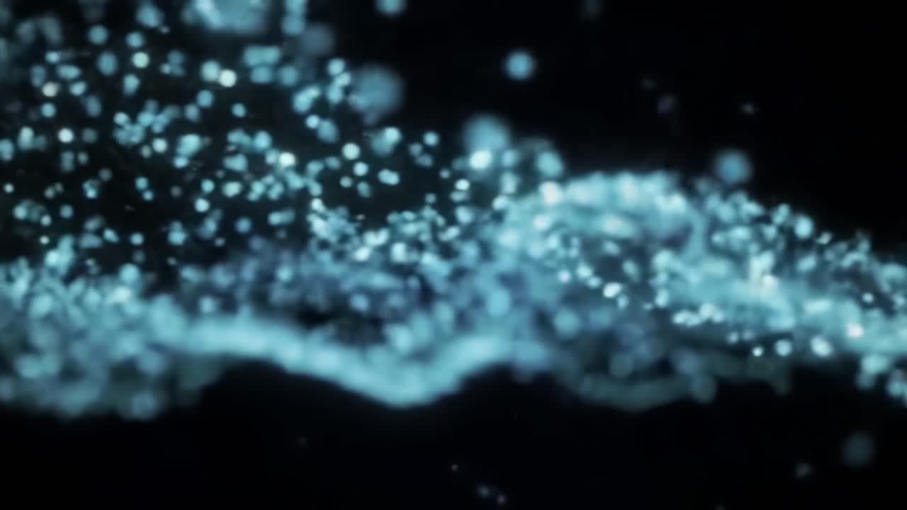 Mesmerizing Patterns of Water Particles Under Low Light: A Dance of Light and Fluid Dynamics Captured in Slow Motion to Showcase Fluidity and Serene Beauty