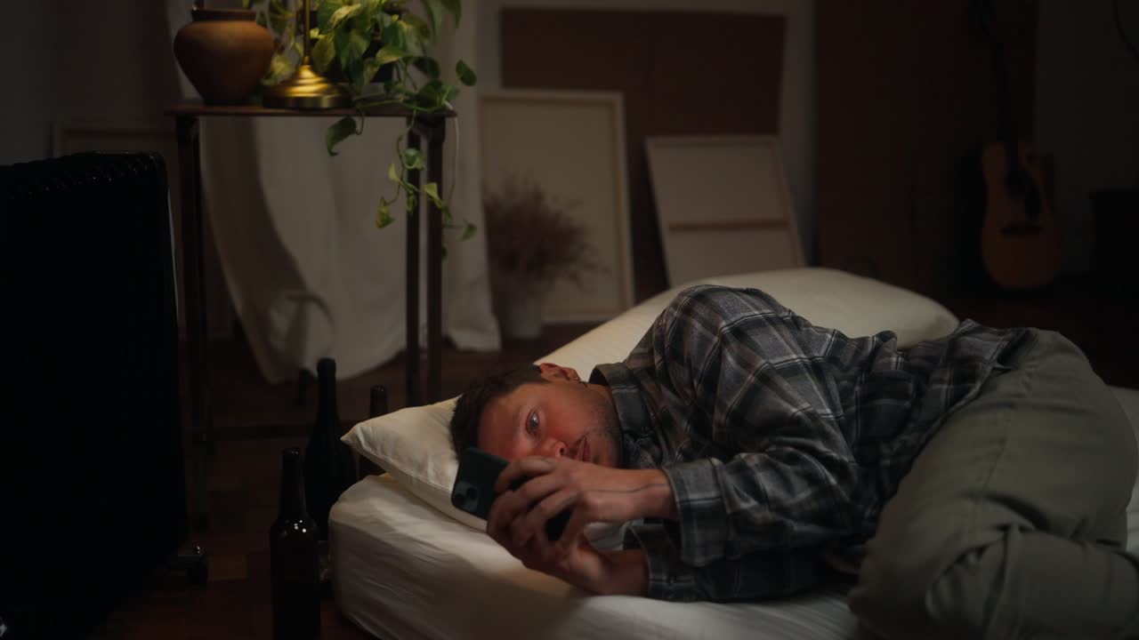 Man Laying in Bed on Phone at Night