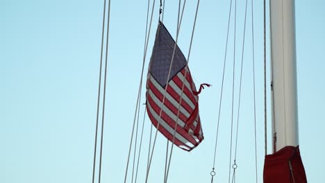 american flag flapping in the wind on a sailboat mast