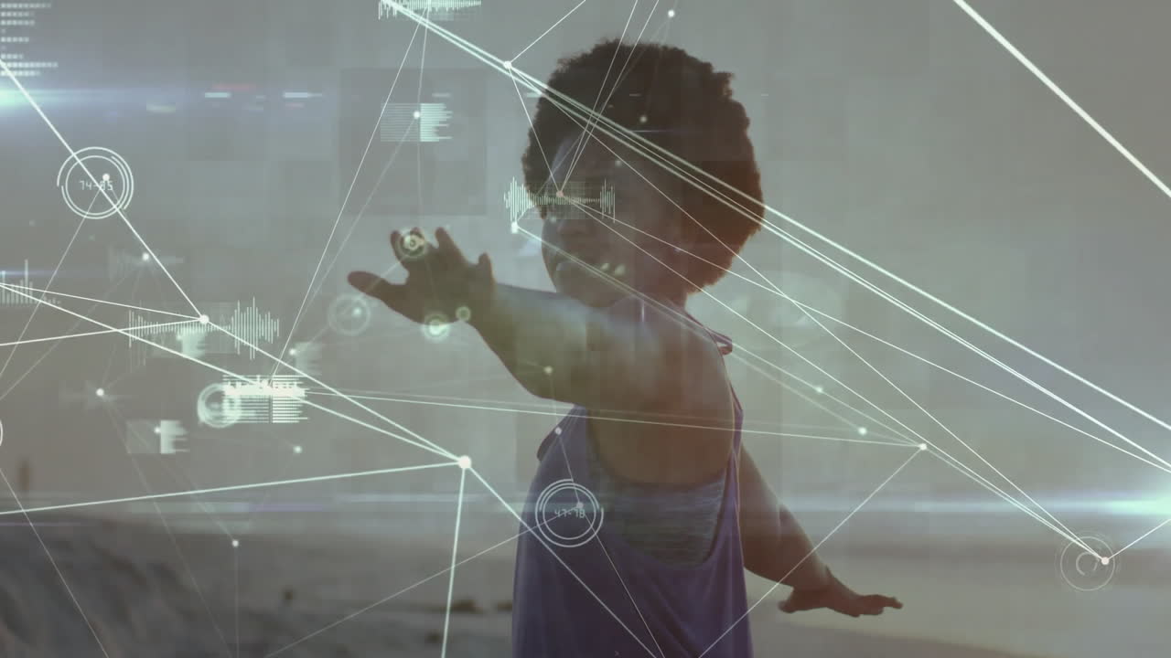 Child on beach, playing with animation of digital network connections overlay