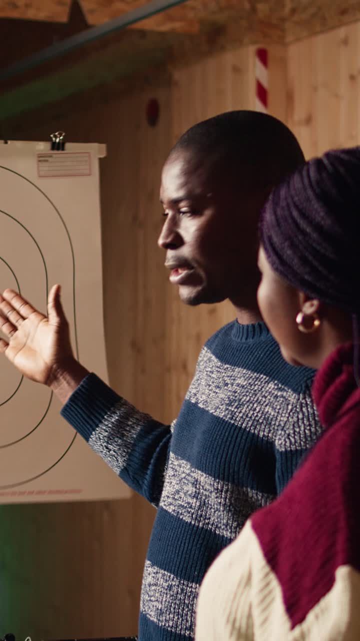 Vertical video Shooting gallery expert explaining bullseye scoring system and reading rules