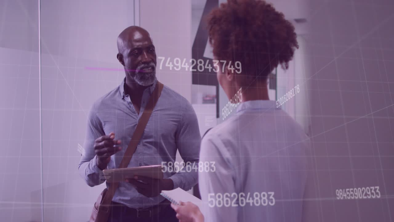 Woman handing document to man tapping tablet while data overlays emerging for business analysis