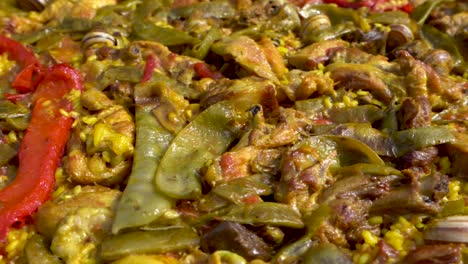 close up shot of a delicious seafood paella, a typical spanish mediterranean dish, pan from right to left