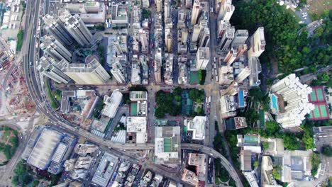 Central-Hong-Kong,-top-down-aerial-view-of-traffic-and-city-skyscrapers