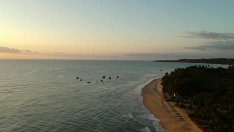 aerial footage over tropical beach at sunrise