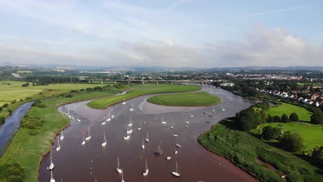 Steigender-Luftblick-über-Den-Fluss-Exe-Von-Topsham-Mit-Blick-Auf-Exeter-An-Einem-Sonnigen-Tag