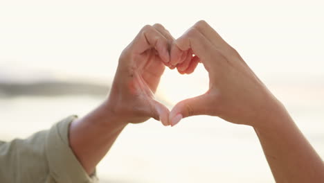 couple, hands and heart emoji on beach for love