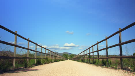 Endless-path-through-picturesque-Mallorca-landscape-with-mountains-and-moving-clouds-in-the-background