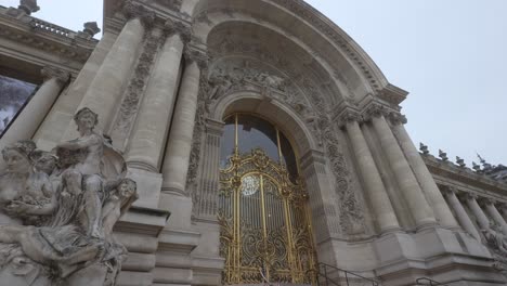 entrance of a temple with large sculptures with a golden fence