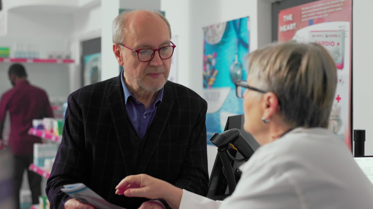 Pharmacist consulting with customer in pharmacy