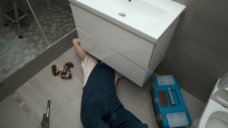 plumber fixing sink