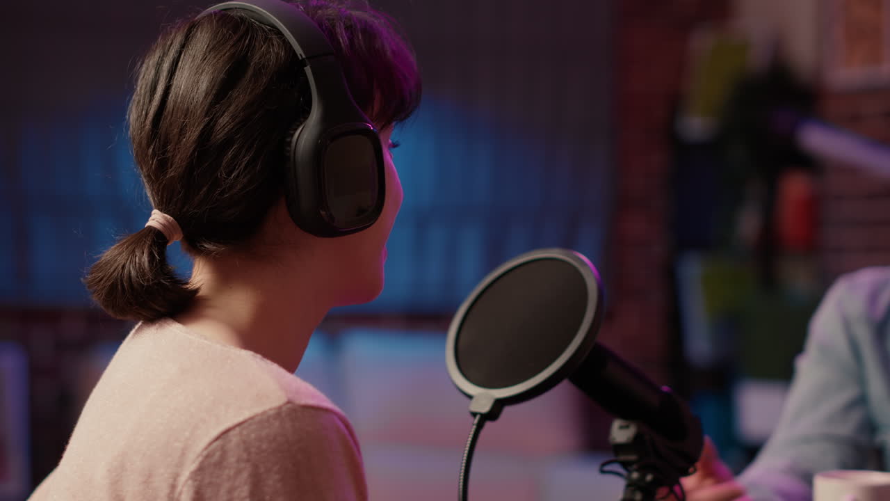 Closeup of famous influencer in online radio show talking with male host about social media success