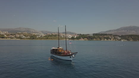 Low-aerial-retreat-from-large-tourism-sailboat-in-Croatia