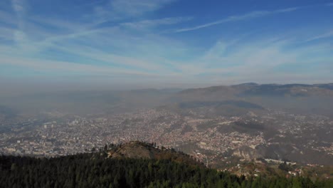 the city of sarajevo is situated within a valley, surrounded by mountains