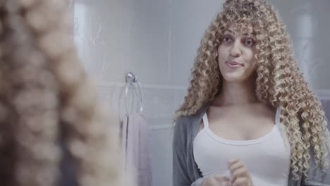 woman applying and holding lipstick in a bathroom, reflected in a mirror