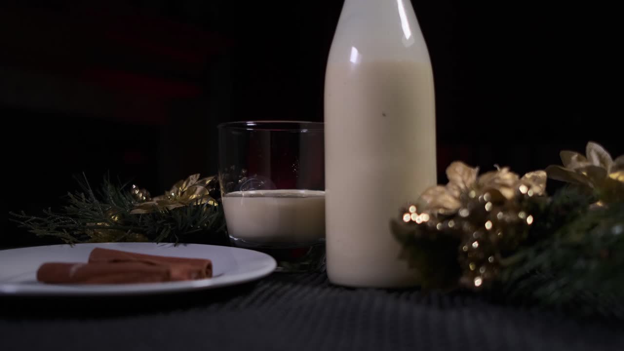 La mano di un uomo afroamericano ripone una bottiglia di Eggnog natalizio, una bevanda tradizionale delle feste