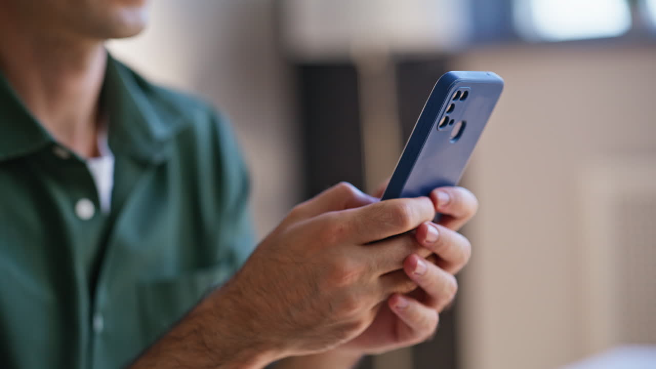 Employee chatting online smartphone sitting workplace closeup. Unknown man