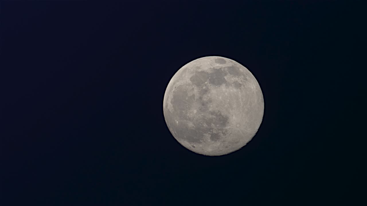 Lua Cheia no céu noturno escuro de inverno de fevereiro com algumas nuvens passando