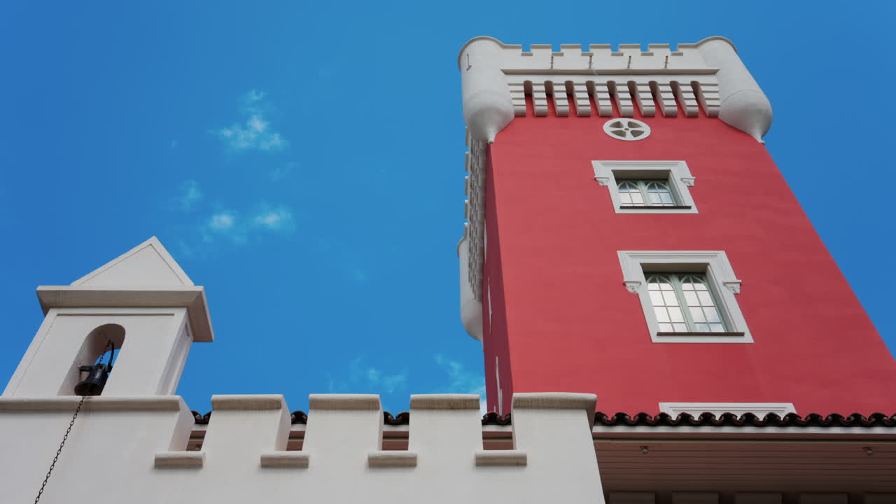 Nice, France - May 17, 2025: The red tower of the Cremat Castle Winery over the blue sky