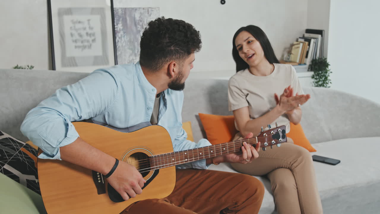 Man Playing Guitar Songs To His Beloved Woman
