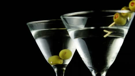 Two-cocktail-glasses-garnished-with-green-olives