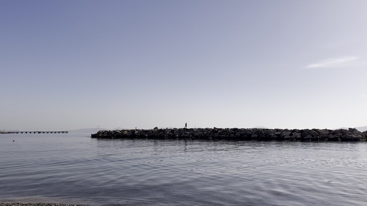 child running and playing on the pier in the sea