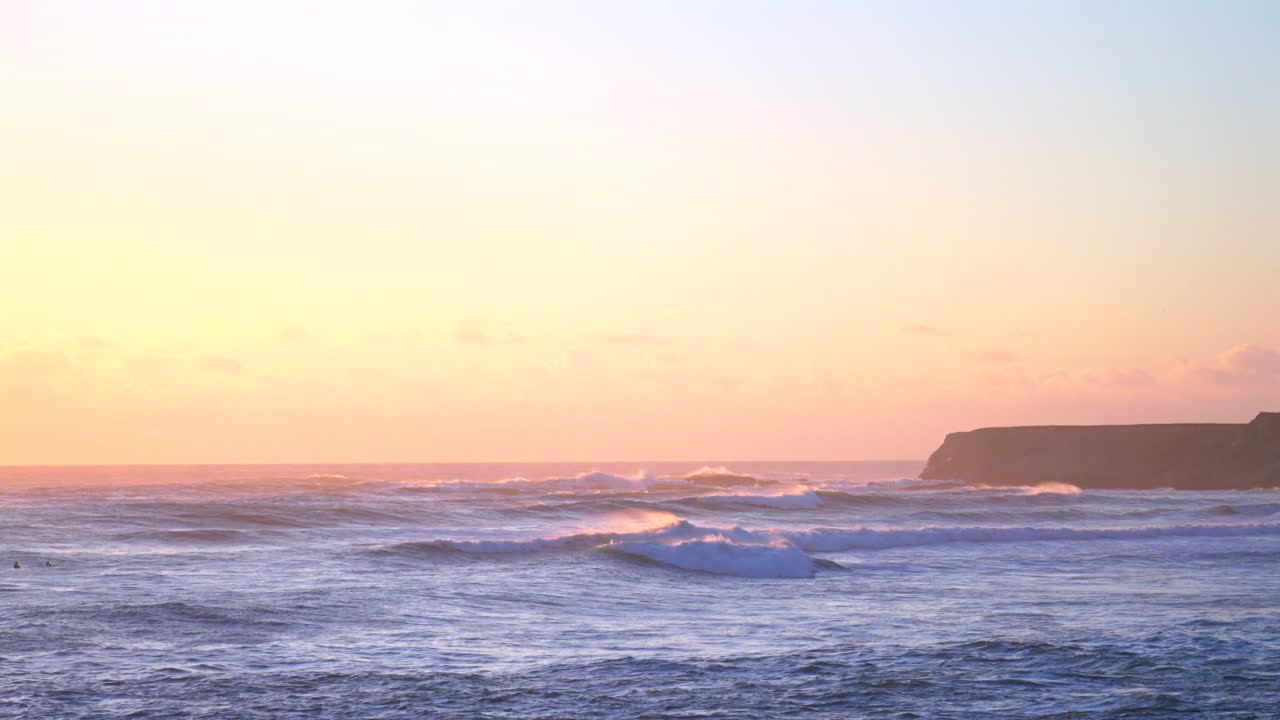 Sunset pink golden huge surf waves swell Point Arena Cove Northern California fall winter cold Pacific Ocean point break wind pink purple dusk fishing pier Mendocino County Fort Bragg static shot