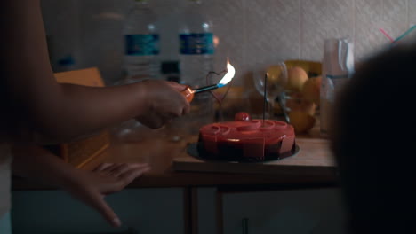 Woman-firing-sparklers-on-festive-cake