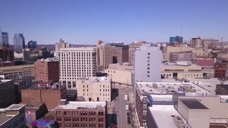 Buildings-and-streets-in-sunlight-in-Grand-Rapids,-MI,-forward-aerial