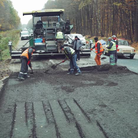 asphalt pavers working on construction site