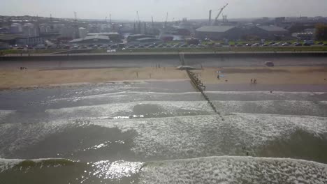 Drone-Moving-Backwards-Over-City-Beach