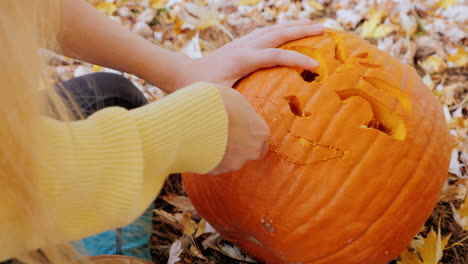 young woman carves a pumpkin 1