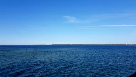 view of the ocean and clouds in the sky. blue sky with clouds in sunny weather over the ocean.