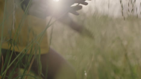 beautiful young indian woman hiking in wilderness grass field outdoors smiling looking happy enjoying  travel adventure alone independent female tourist