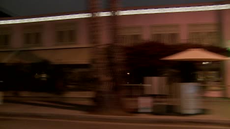 a car travels along a street at night in santa monica california as seen through the side window 5