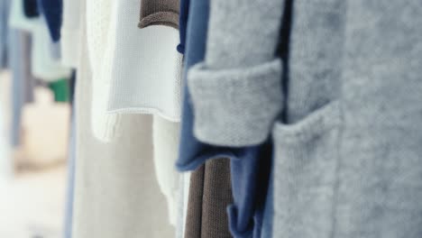 modern clothes hanging in store, close up view