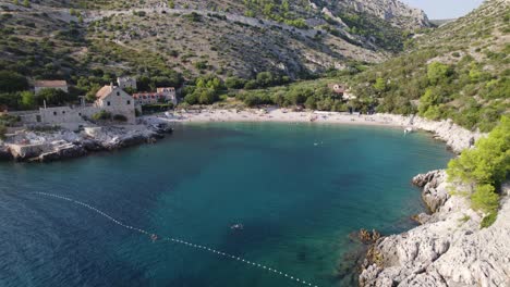 aerial view of dubovica beach, hvar, with village and sunlit shores