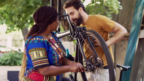 multiethnic couple fixes damaged bicycle