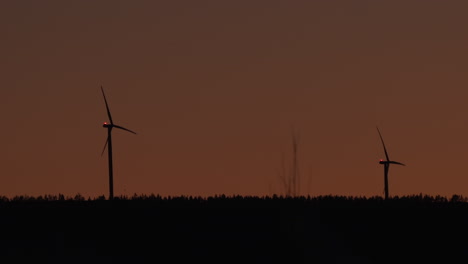 wind power generator turbines, at a sunny, evening dusk, in hoga kusten, vasternorrland, sweden