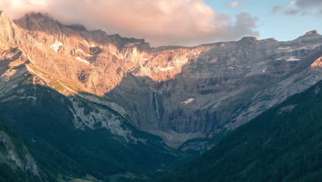 Timelapse-of-sunset-in-Gavarnie-Valley,-The-little-town-of-Gavarnie-as-foreground-and-the-big-waterfall-as-background