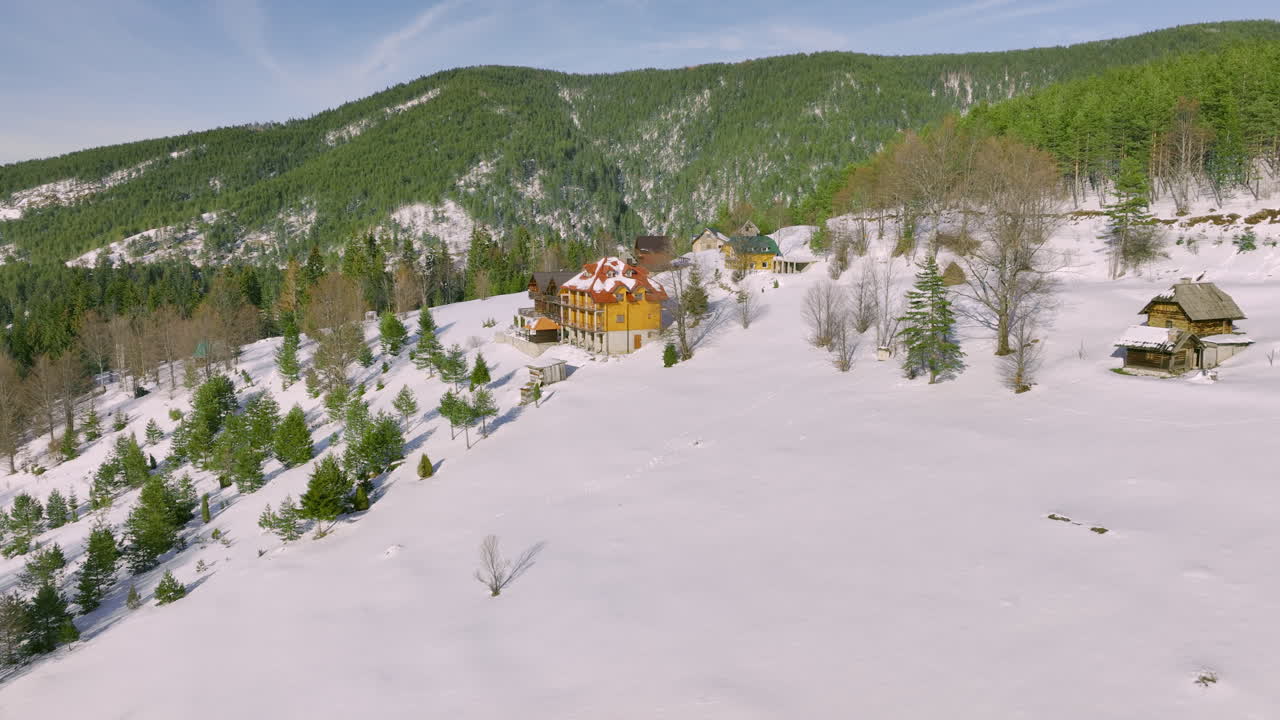 Winter Mountain Village with Traditional Houses and Snow-Covered Forests