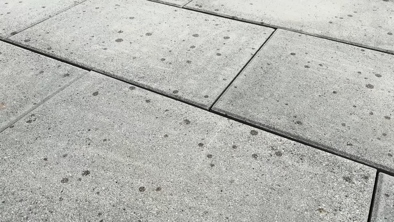 it starts to rain, raindrops fall on dry paving slabs, garden tiles