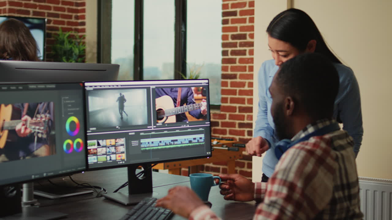Creative filmmakers doing teamwork to edit video footage