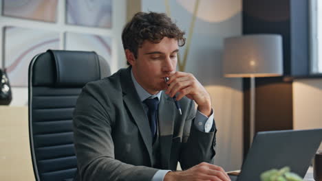 overloaded businessman shutting laptop lid at office closeup. sleepy man rest