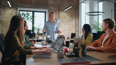 professional business consultant explaining strategy to workers in boardroom.