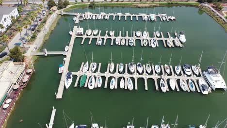 drone footage flying up and away of redwood harbor and boat slips