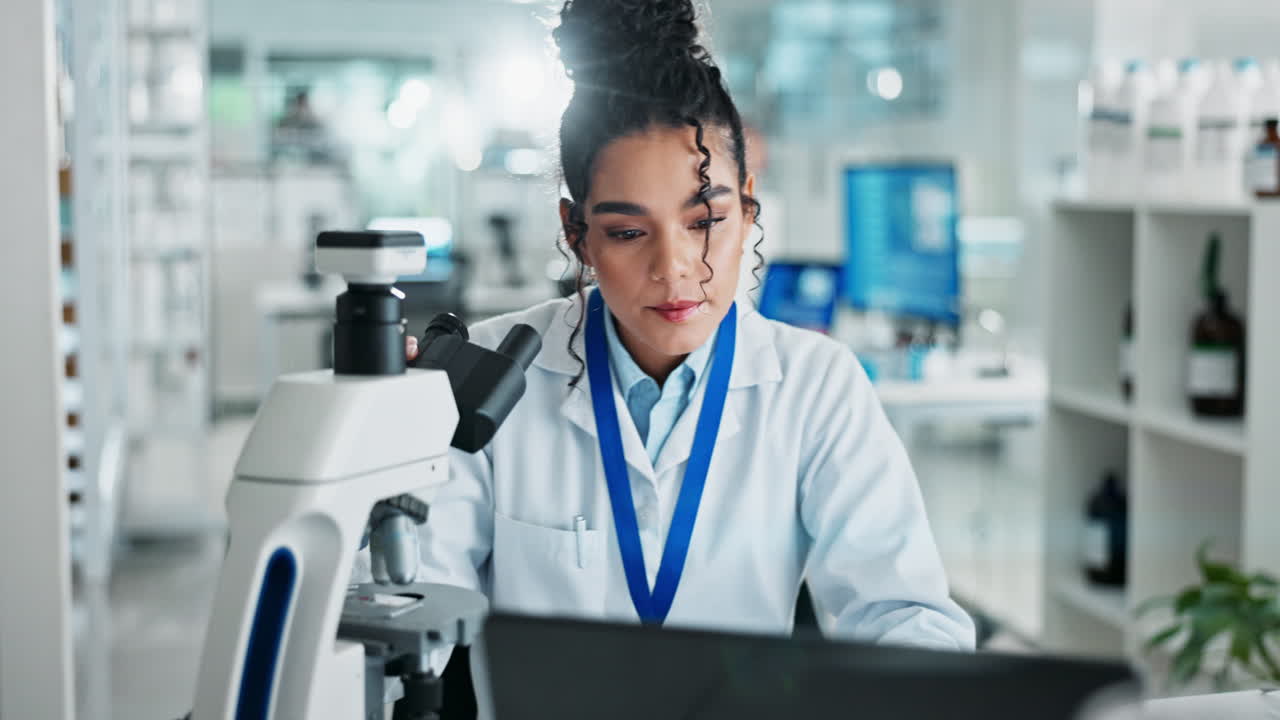 Scientist Using Microscope in Laboratory