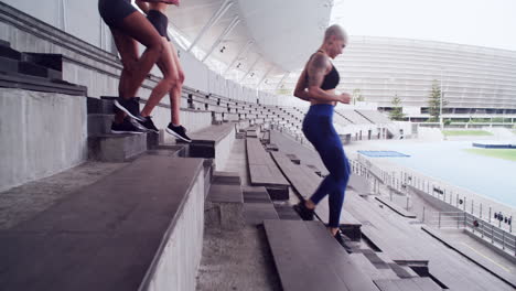 women athletes exercising in a stadium