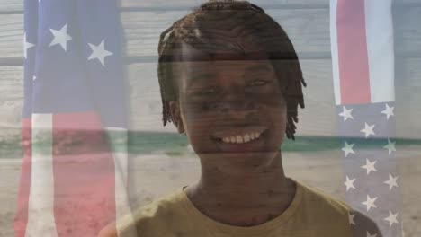 animation of happy african american man by sea over flag of usa